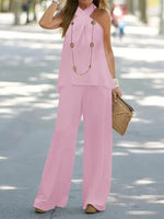 Woman in a pink outfit walking outdoors on a sunny day.