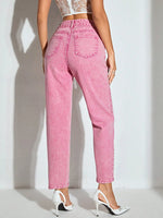 Person wearing pink jeans on a white background