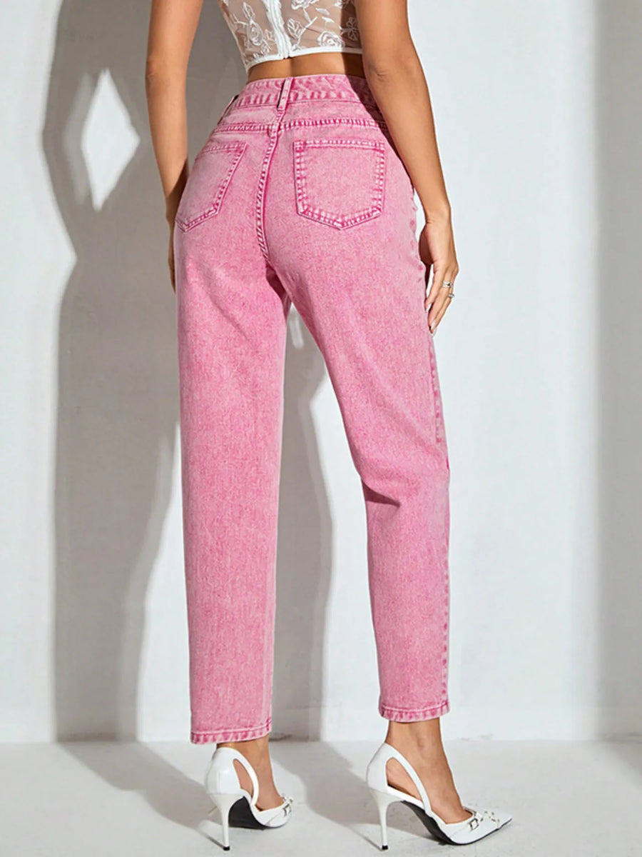 Person wearing pink jeans on a white background