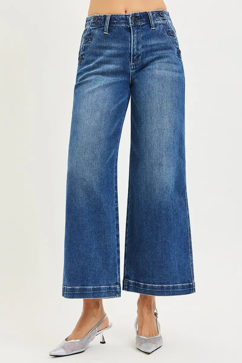 Blue jeans worn by a person on a white background