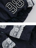 Navy blue fabric with white lace detailing on a light gray background