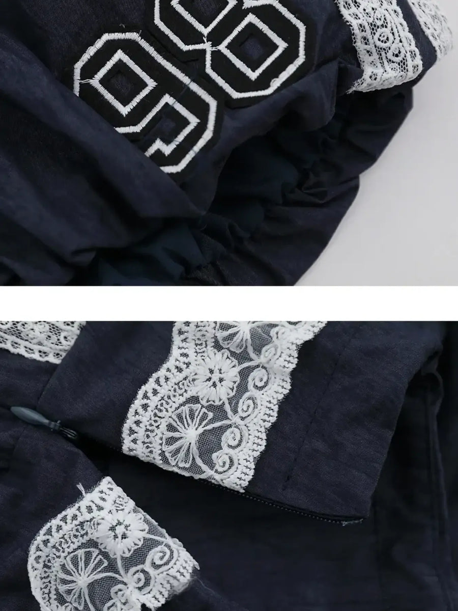 Navy blue fabric with white lace detailing on a light gray background