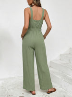 Woman wearing a green jumpsuit on a white background