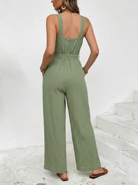 Woman wearing a green jumpsuit on a white background