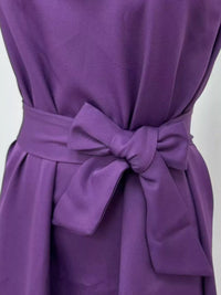 Purple dress with a large bow detail on a white background