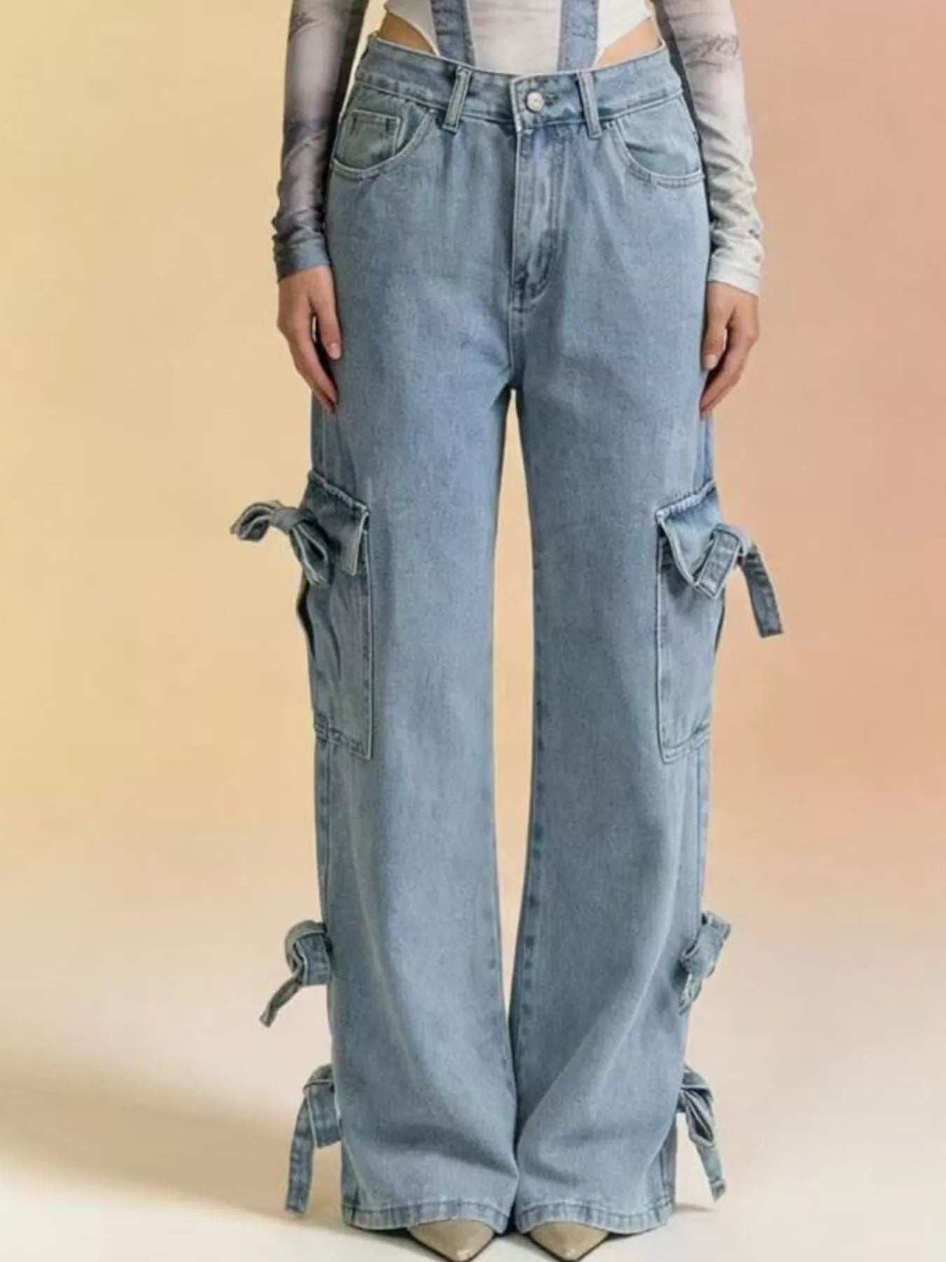 Blue denim cargo overalls worn by a person on a beige background