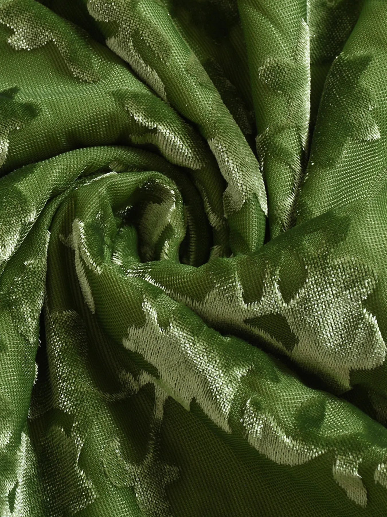 Close-up of green fabric with a subtle pattern