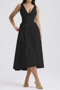 Black dress worn by a model on a white background