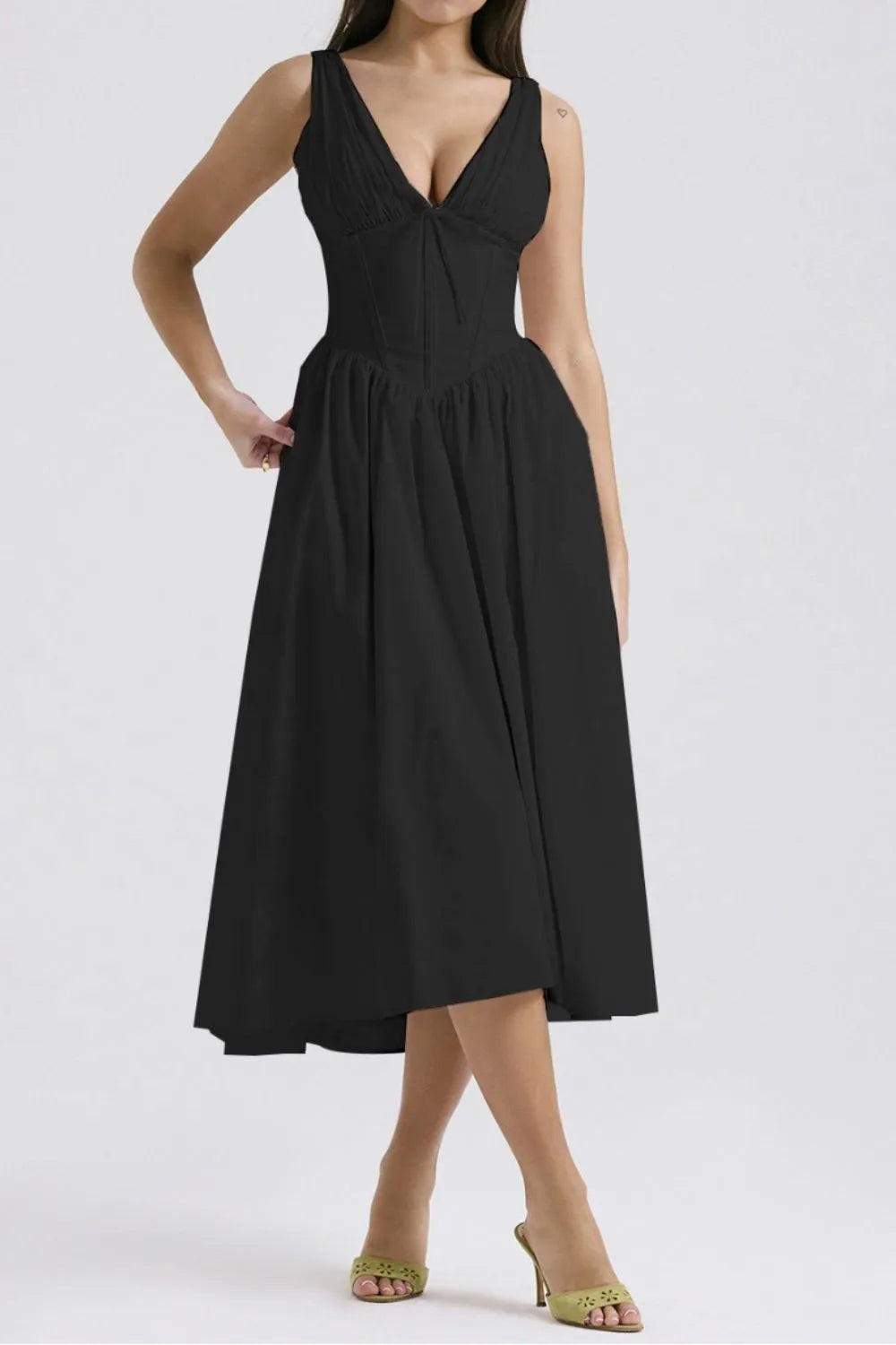 Black dress worn by a model on a white background