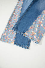 Folded denim fabric with floral pattern on a white background