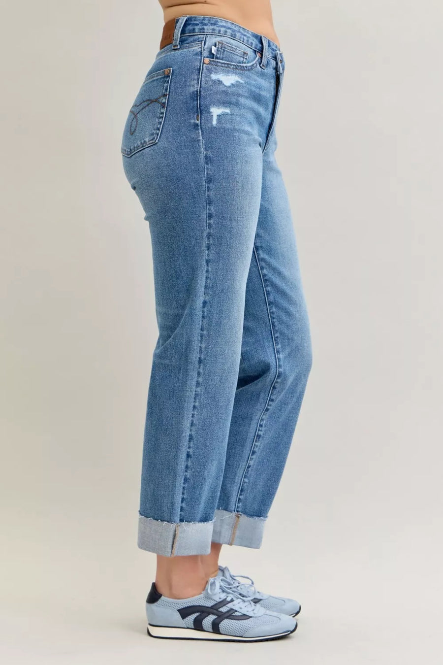 Light blue jeans worn by a person on a plain background