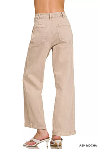 Beige pants worn by a person on a white background