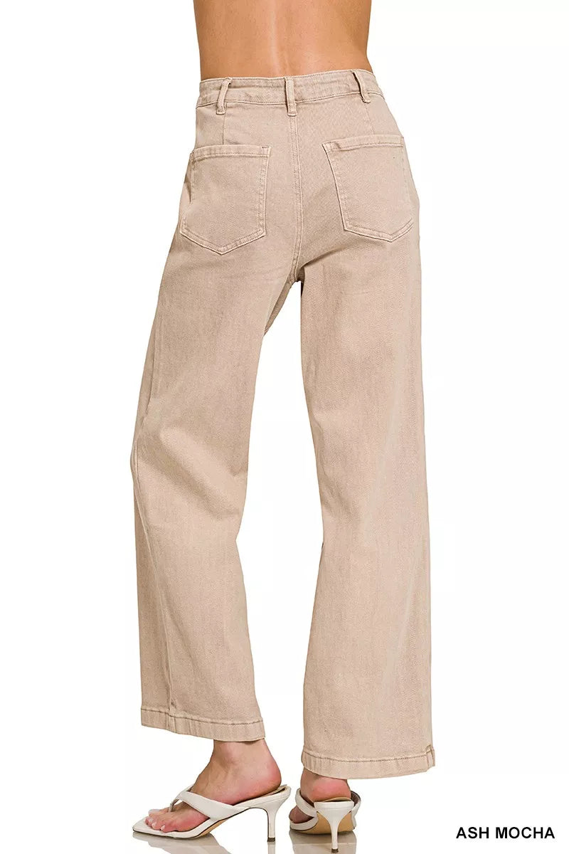 Beige pants worn by a person on a white background