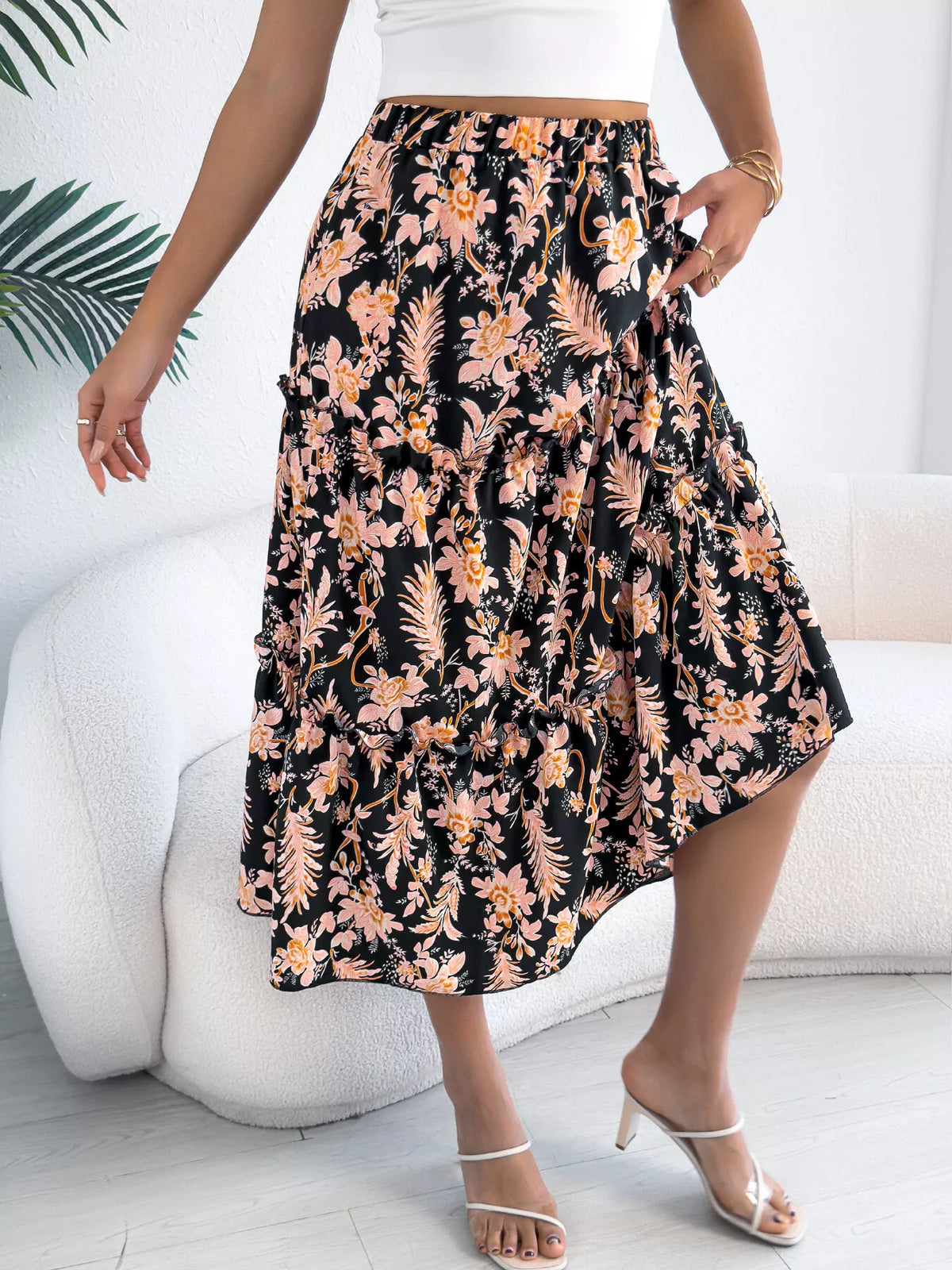 Person wearing a floral skirt with a white background