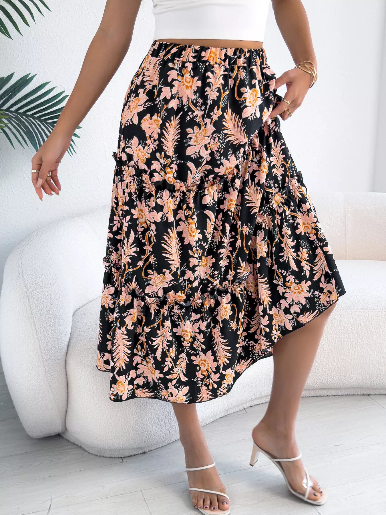 Person wearing a floral skirt with a white background