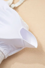 Close-up of a white shirt collar on a beige background