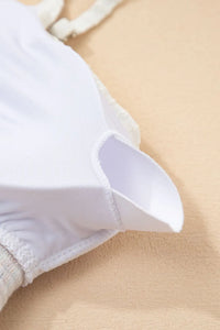 Close-up of a white shirt collar on a beige background