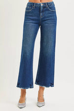 Blue jeans worn by a person on a white background
