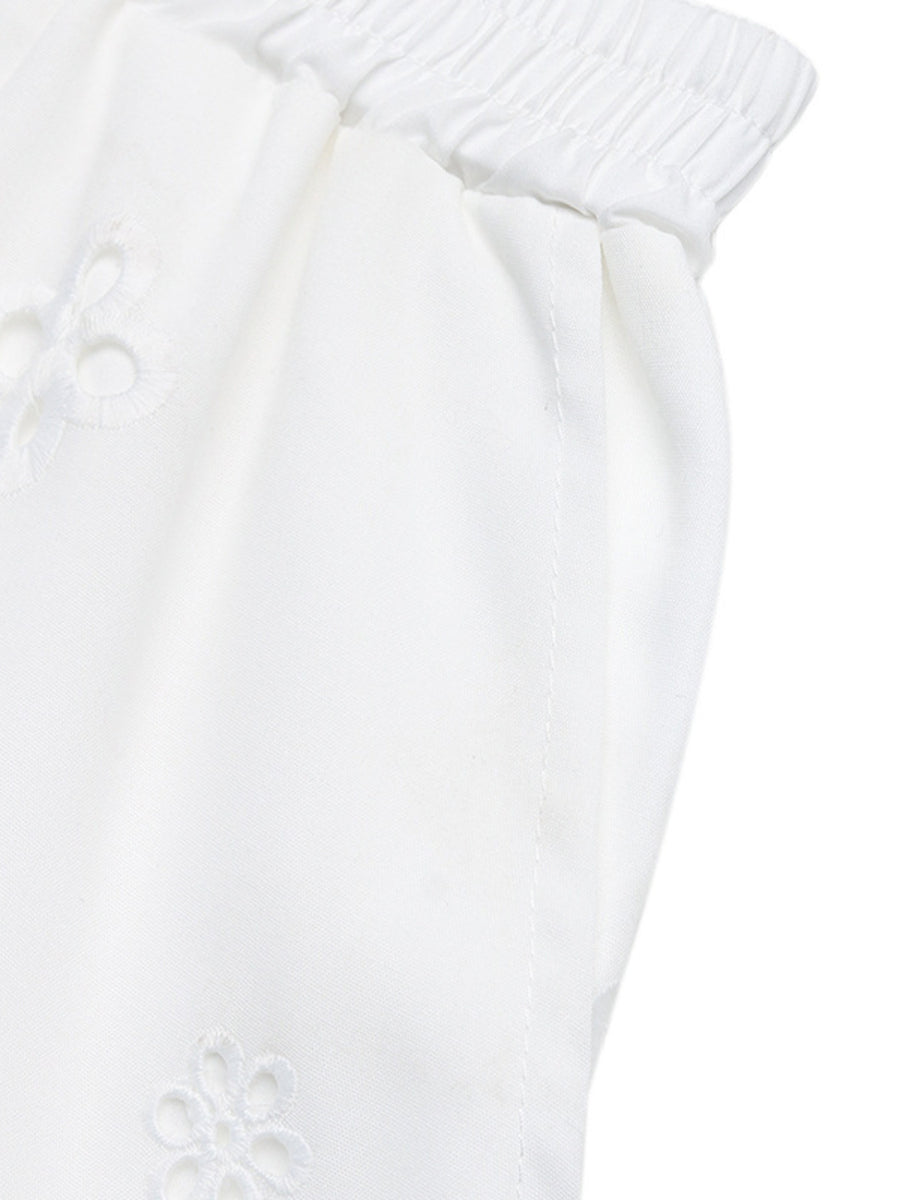 Close-up of a white textured fabric with a subtle pattern on a white background