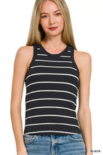Woman wearing a black and white striped tank top on a plain background