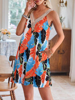 Woman wearing a colorful tropical print dress in a home setting