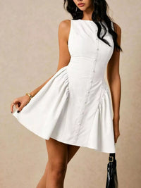 Woman wearing a white dress against a beige background