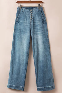 Blue jeans on a hanger against a beige background
