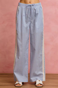 Blue checkered pants with a pink background