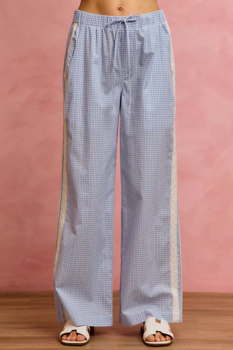 Blue checkered pants with a pink background