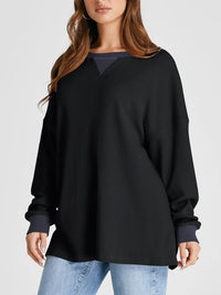 Woman wearing a black sweater with a white background