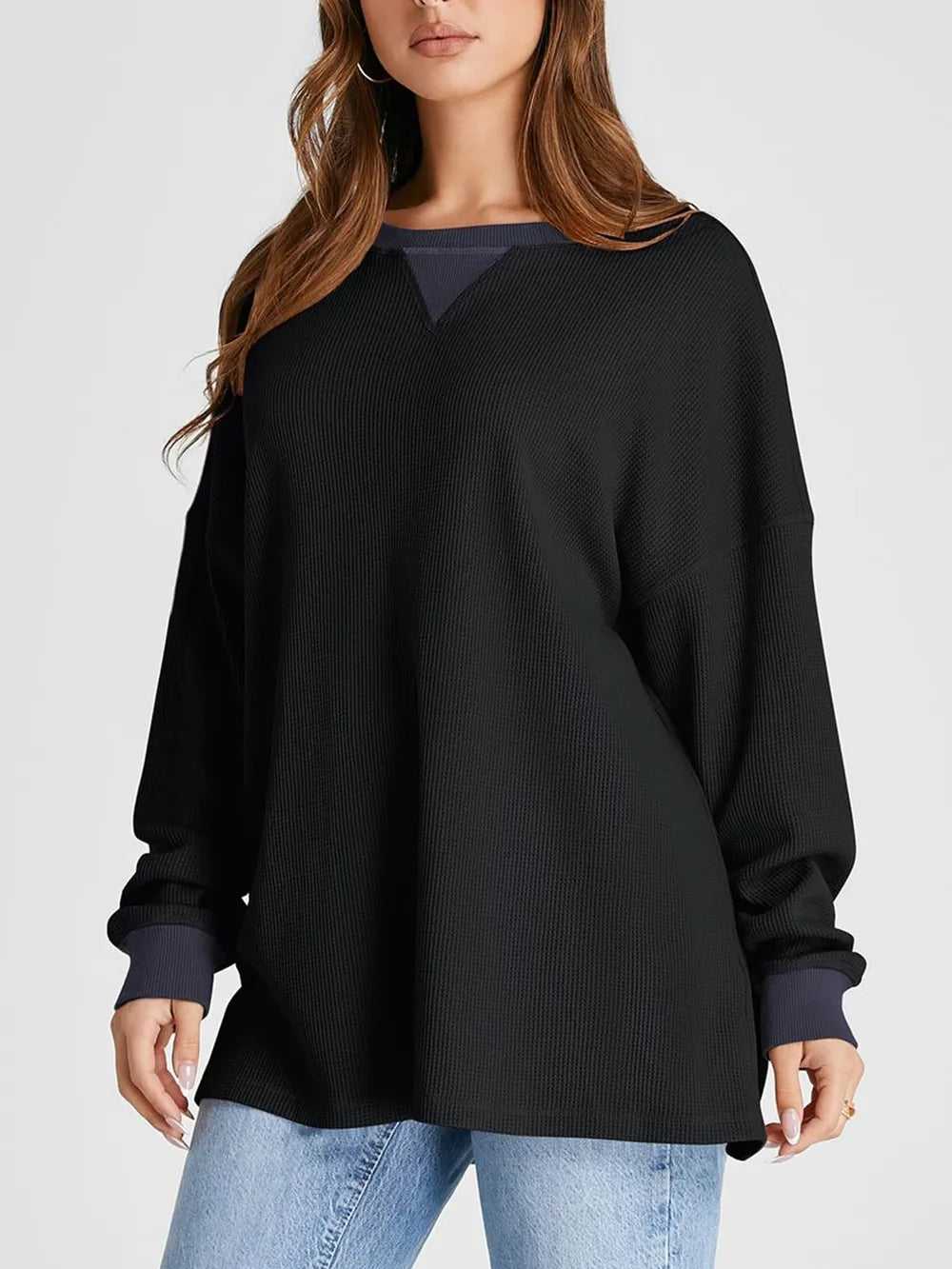 Woman wearing a black sweater with a white background