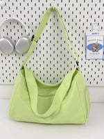 Light green handbag on a white surface with a white wall background