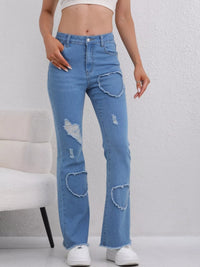 Blue distressed jeans worn by a person on a white background