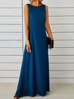 Woman wearing a long blue dress against a wooden background
