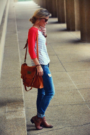 Woman standing on a sidewalk wearing Mi Vida Foldover Tote