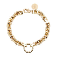 A gold-colored bracelet with a robust brass link chain and a sleek lobster clasp, featuring a striking accent ring.