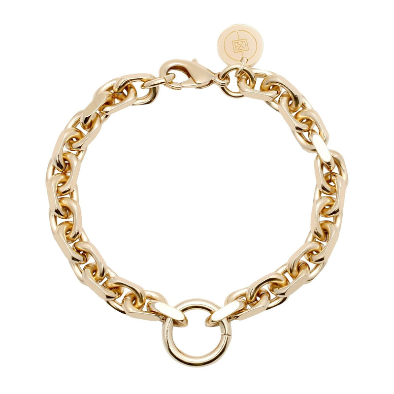 A gold-colored bracelet with a robust brass link chain and a sleek lobster clasp, featuring a striking accent ring.