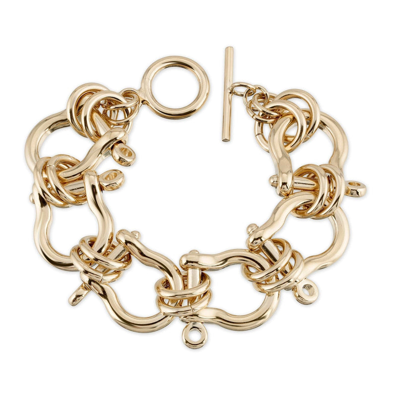 A gold-colored statement bracelet with interlinked chains and a toggle clasp, displayed against a white background.