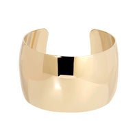 A high polish gold colored large domed cuff bracelet made from recycled brass, displayed against a white background.