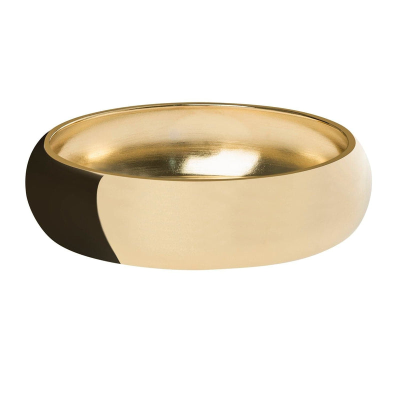 A gold domed recycled brass bangle bracelet with a visible inner wrist area.