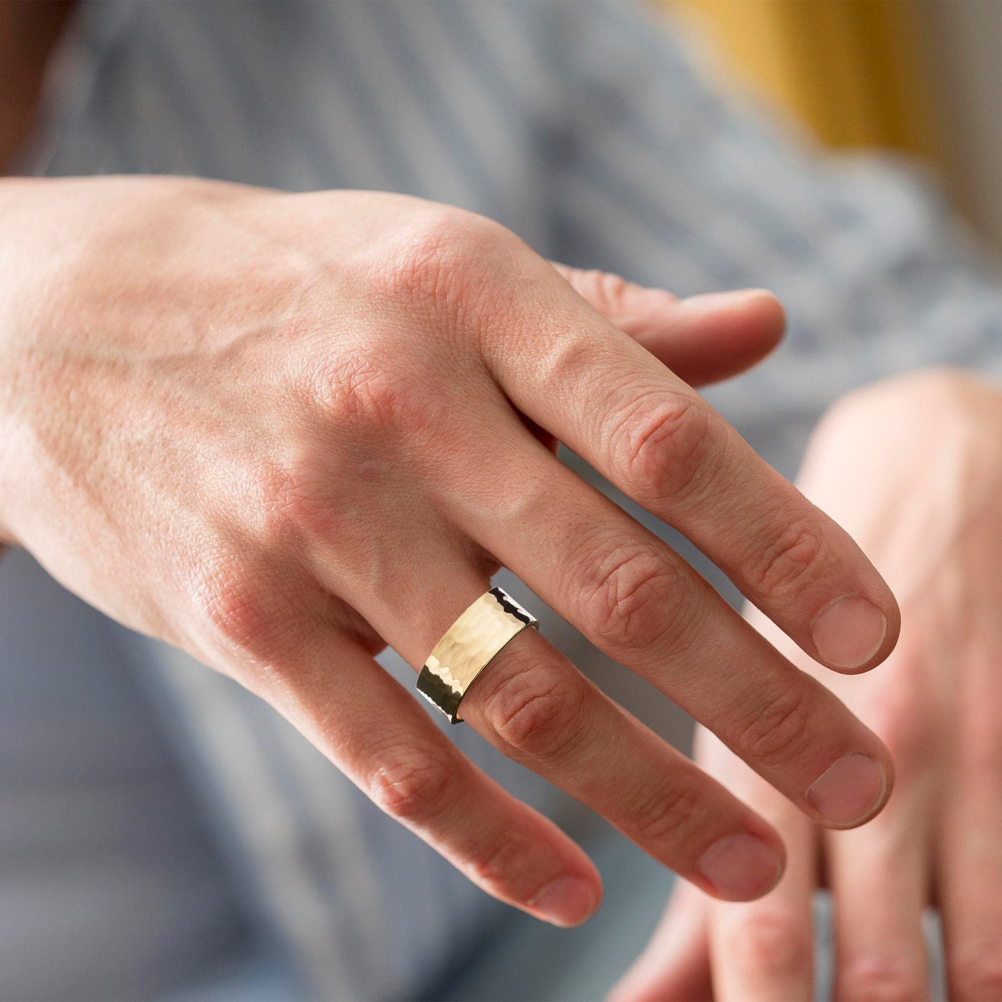 A man showing his hand with Men's 9.5Mm Hammered Ring on