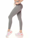 Gray leggings worn by a person on a white background