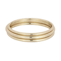 A polished gold-colored round bangle bracelet with a sleek, smooth finish.