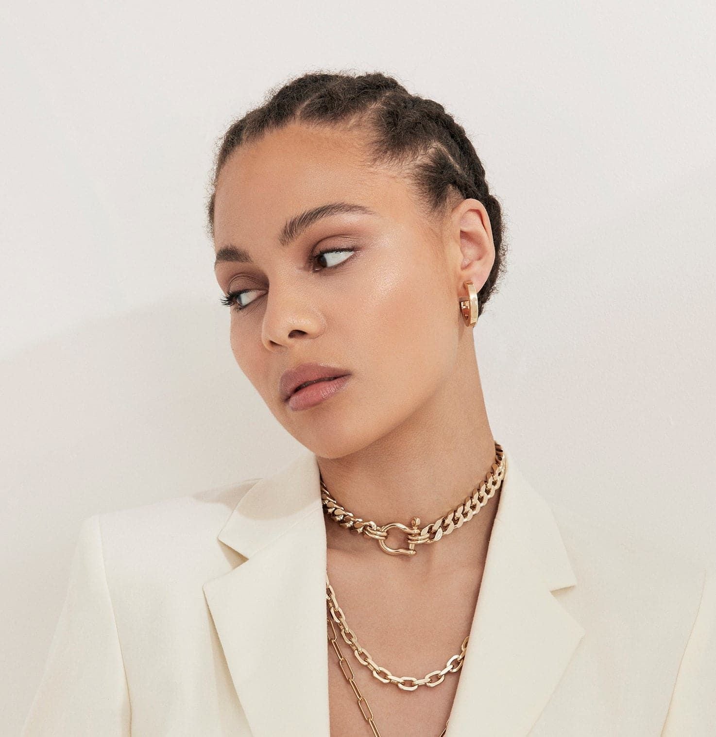 Woman in a white jacket wearing Roxy Necklace 