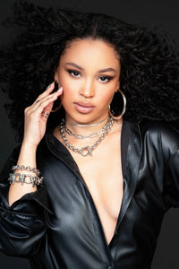 A lady in a black blouse wearing Royal Necklace