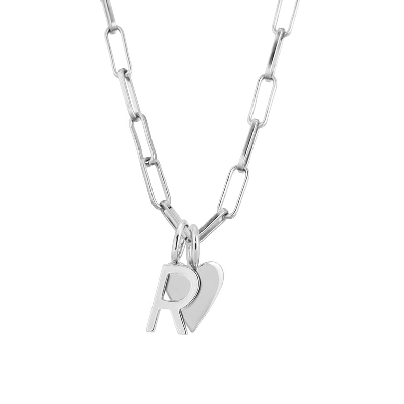 A silver elongated link chain necklace with a heart-shaped charm and a small round pendant.