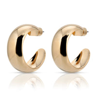 A pair of gold-colored domed hoop earrings made from recycled brass, displayed against a white background.
