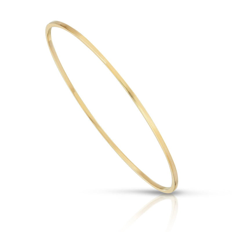 A gold-colored skinny bangle bracelet made from recycled brass wire, displayed against a white background.