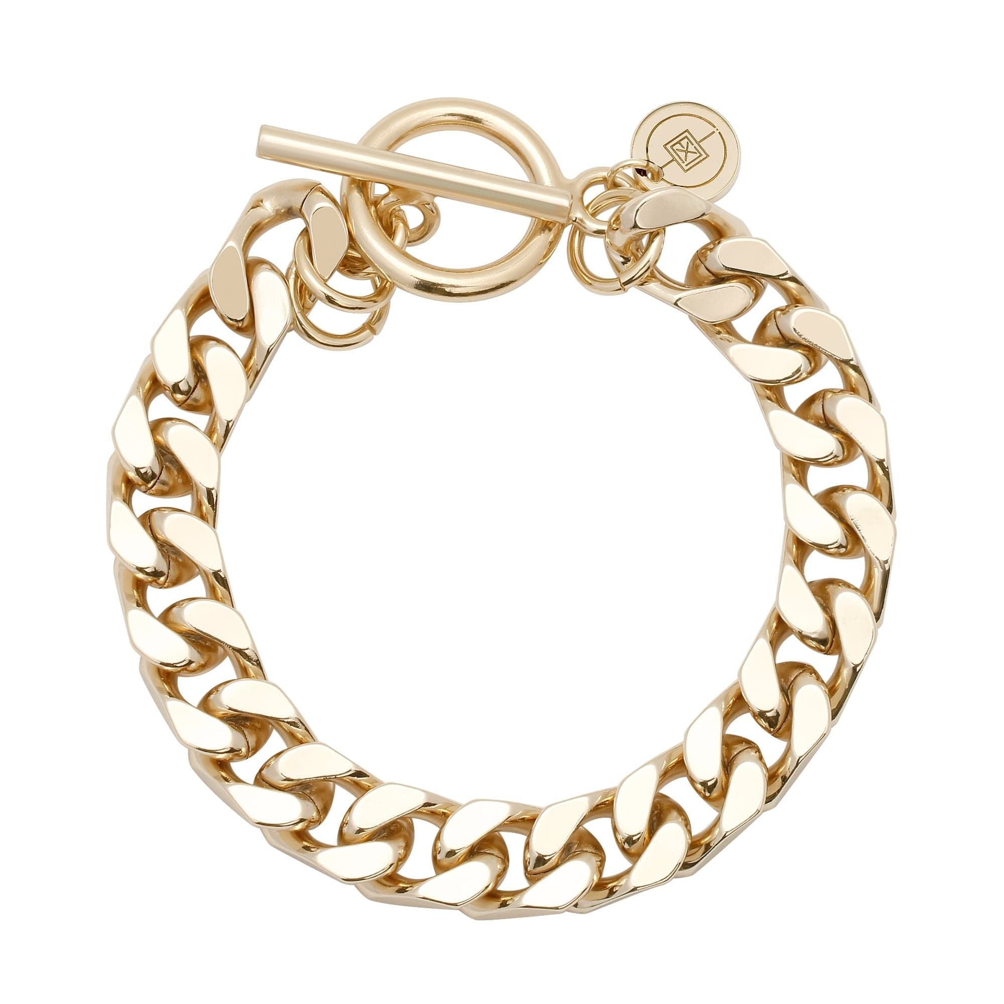 A gold-colored recycled brass curb chain bracelet with a toggle clasp.