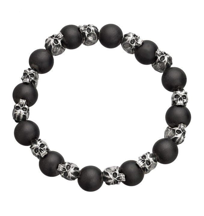 A stretch bracelet with matte black onyx beads and pewter skulls interspersed throughout the design.